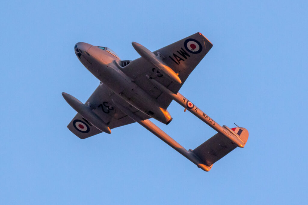 RAF Vampire fighter jet in the air with a blue sky behind